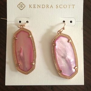 Kendra Scott Elle gold drop earrings in pink.